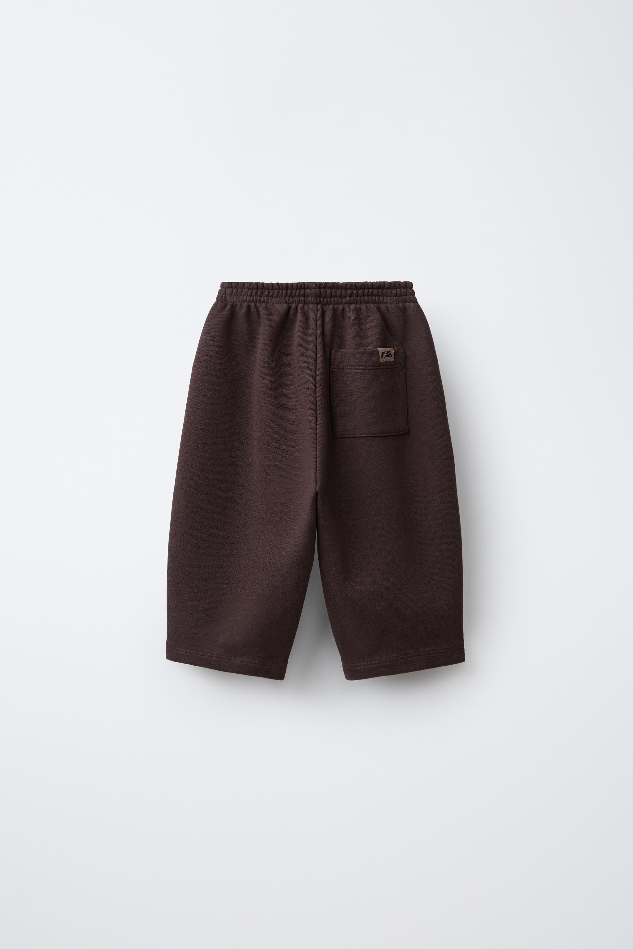 LOT DE DEUX PANTALONS EN MOLLETON RAYÉS ET UNIS