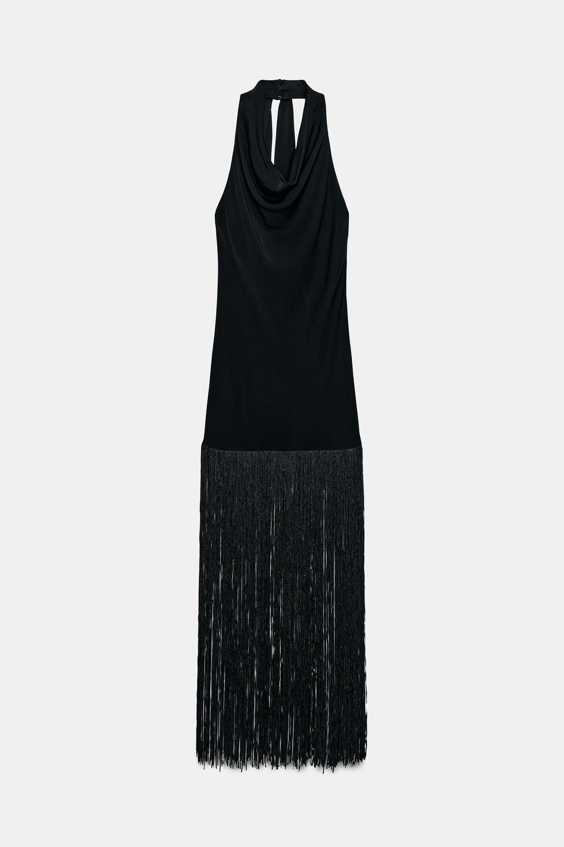 Front view of a black sleeveless dress with a draped neckline and long fringing on the hem.