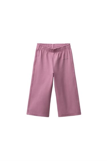 PANTALONS DE PELFA DE CAMA AMPLA AMB MISSATGE EN RELLEU - Rosat fosc de Zara