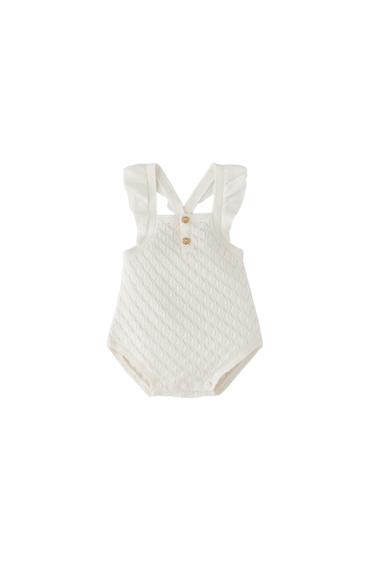 OPEN-KNIT ROMPER WITH RUFFLES