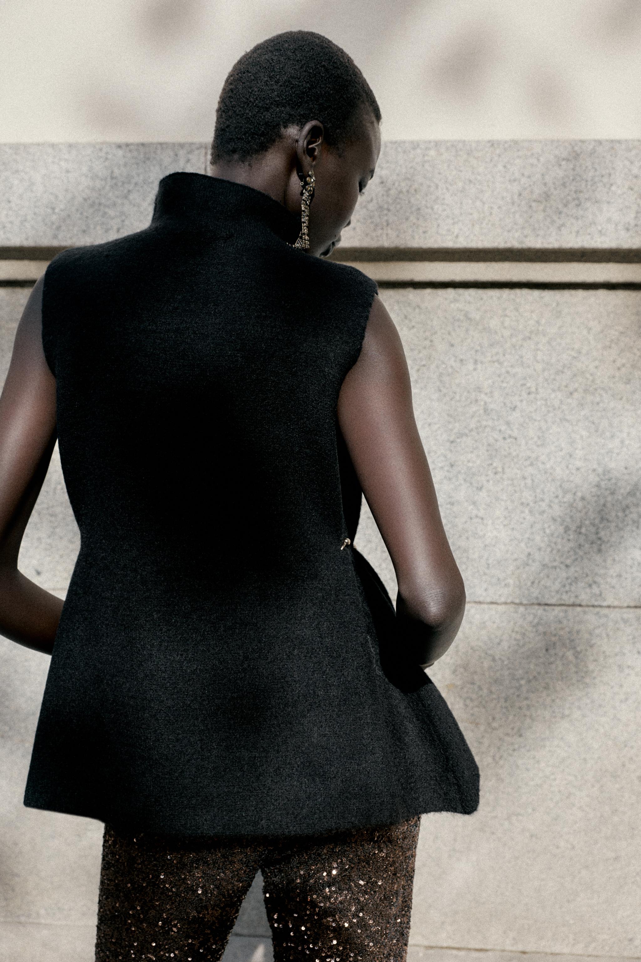 ASYMMETRIC KNIT TOP WITH SIDE APPLIQUÉS