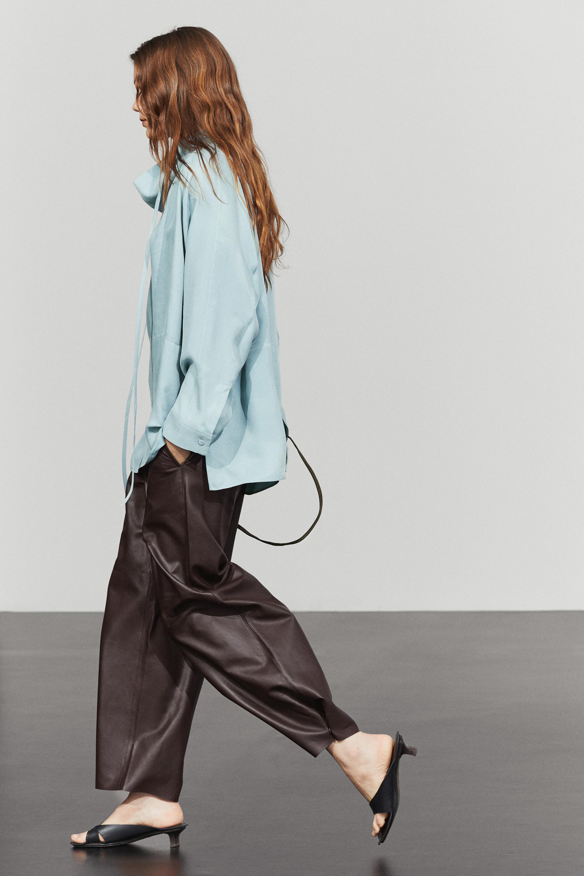 Flowing shirt with high collar and drawstring detail