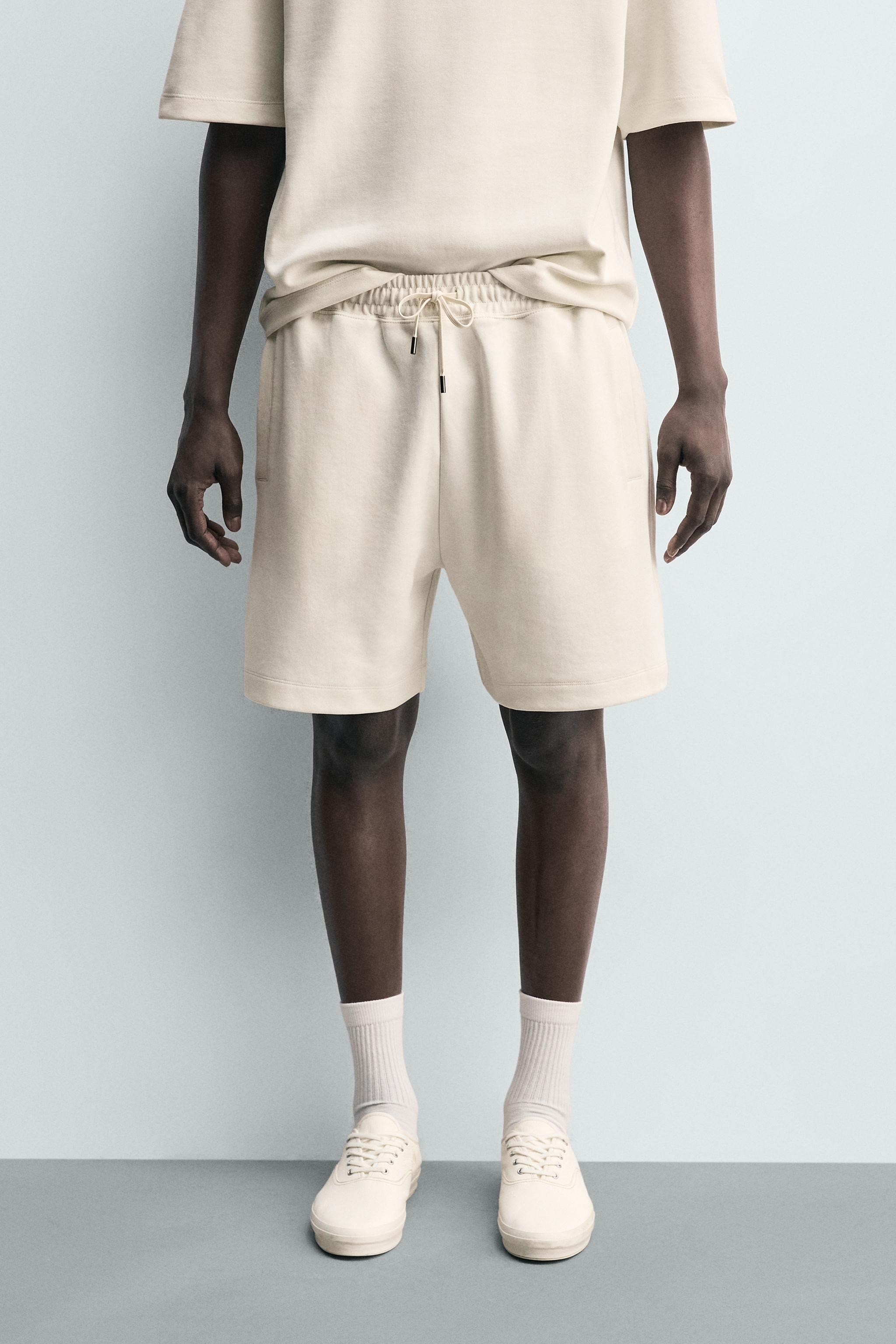 RELAXED FIT INTERLOCK TRACK SHORTS — Oyster-white