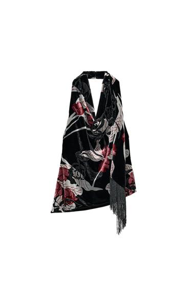 Front view of black halter top with fuchsia floral print and fringing on the hem. Open back.