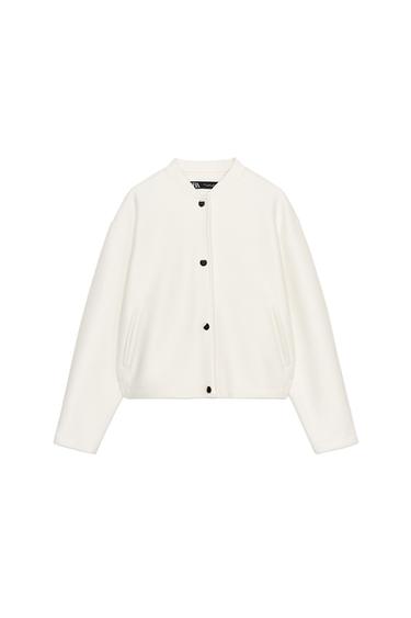 Front view of a raw bomber jacket with a crew neck, long sleeves, front pockets and black snap fasteners.