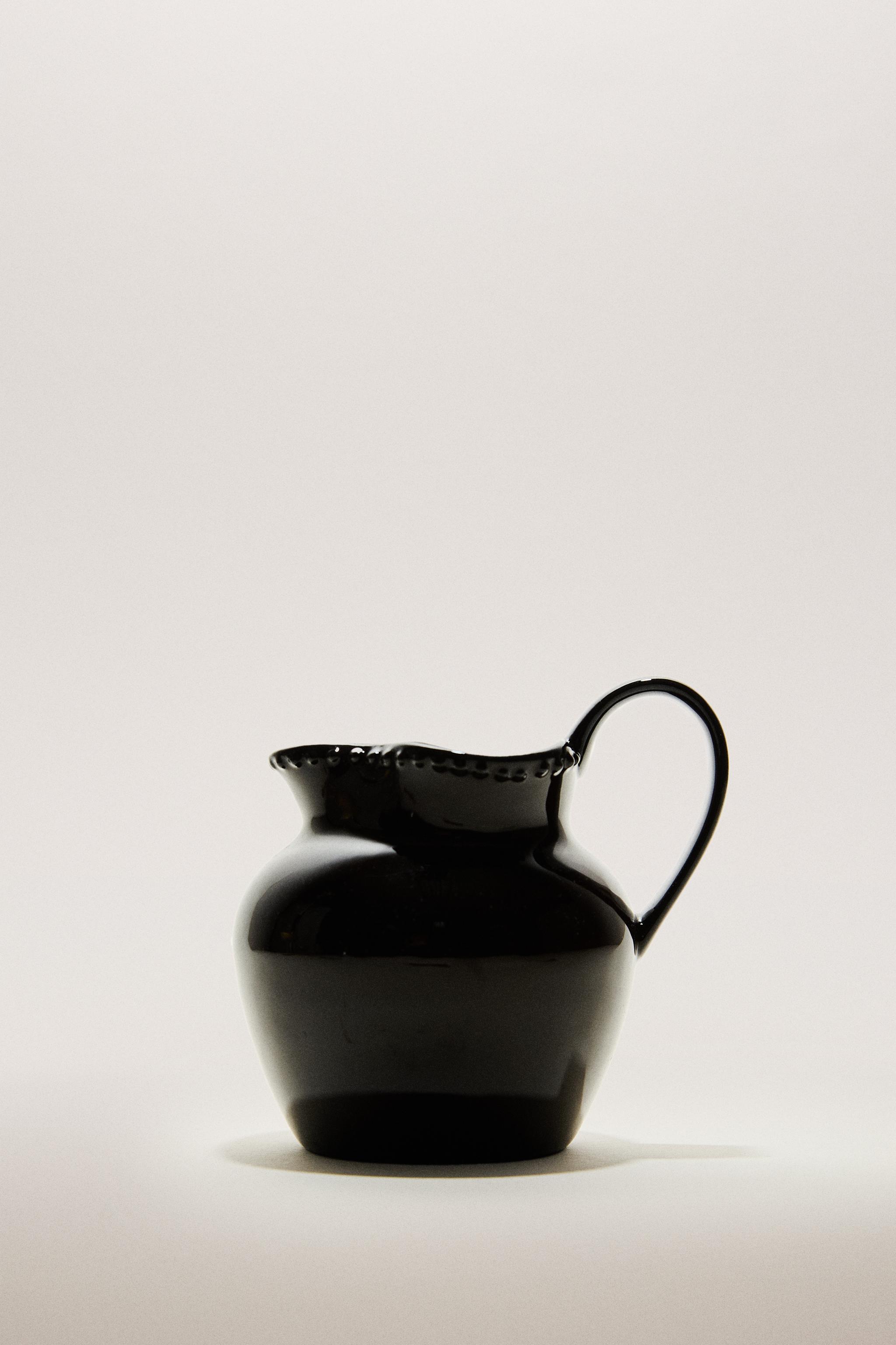 RAISED DESIGN STONEWARE JUG
