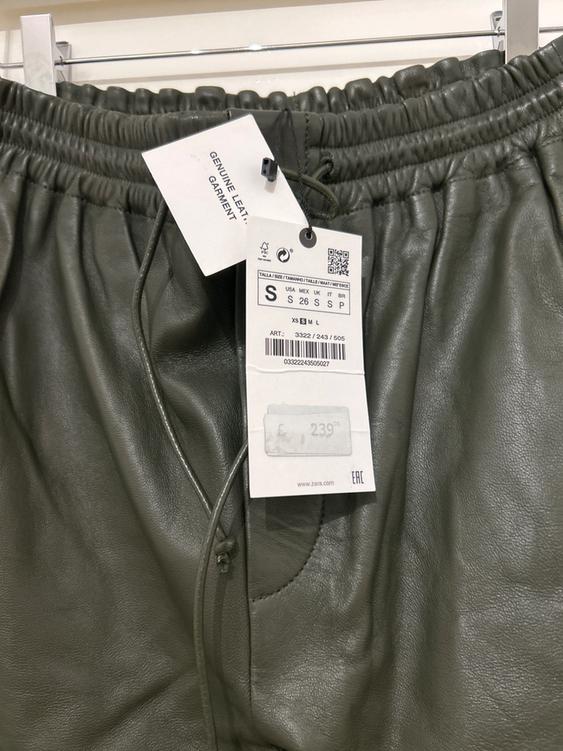 Olive green leather trousers with label that reads "GENUINE LEATHER GARMENT". Size S, price £239.00. Visible brand: zara.com.