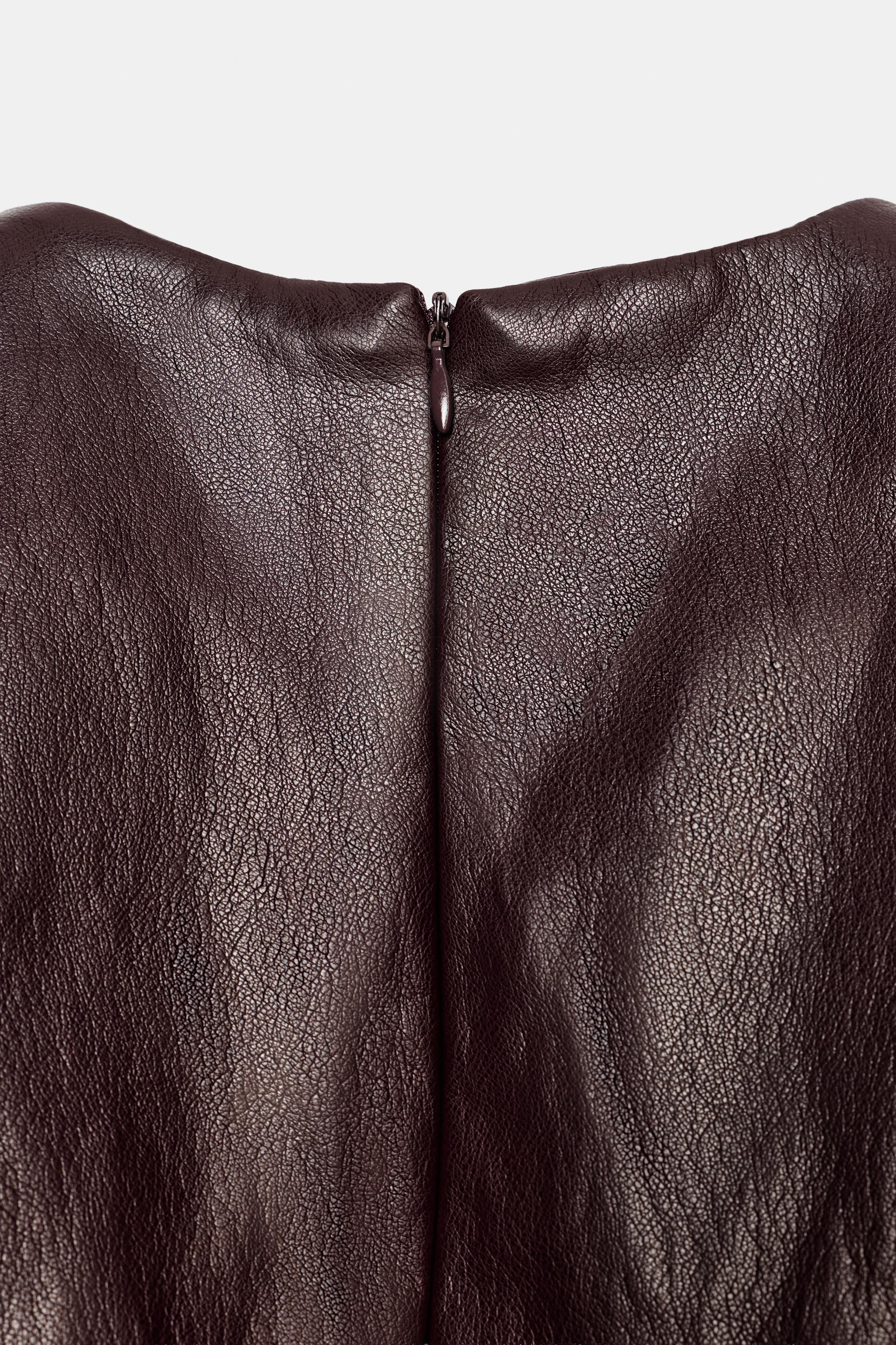 FAUX LEATHER TOP WITH GOLD-TONE APPLIQUÉS