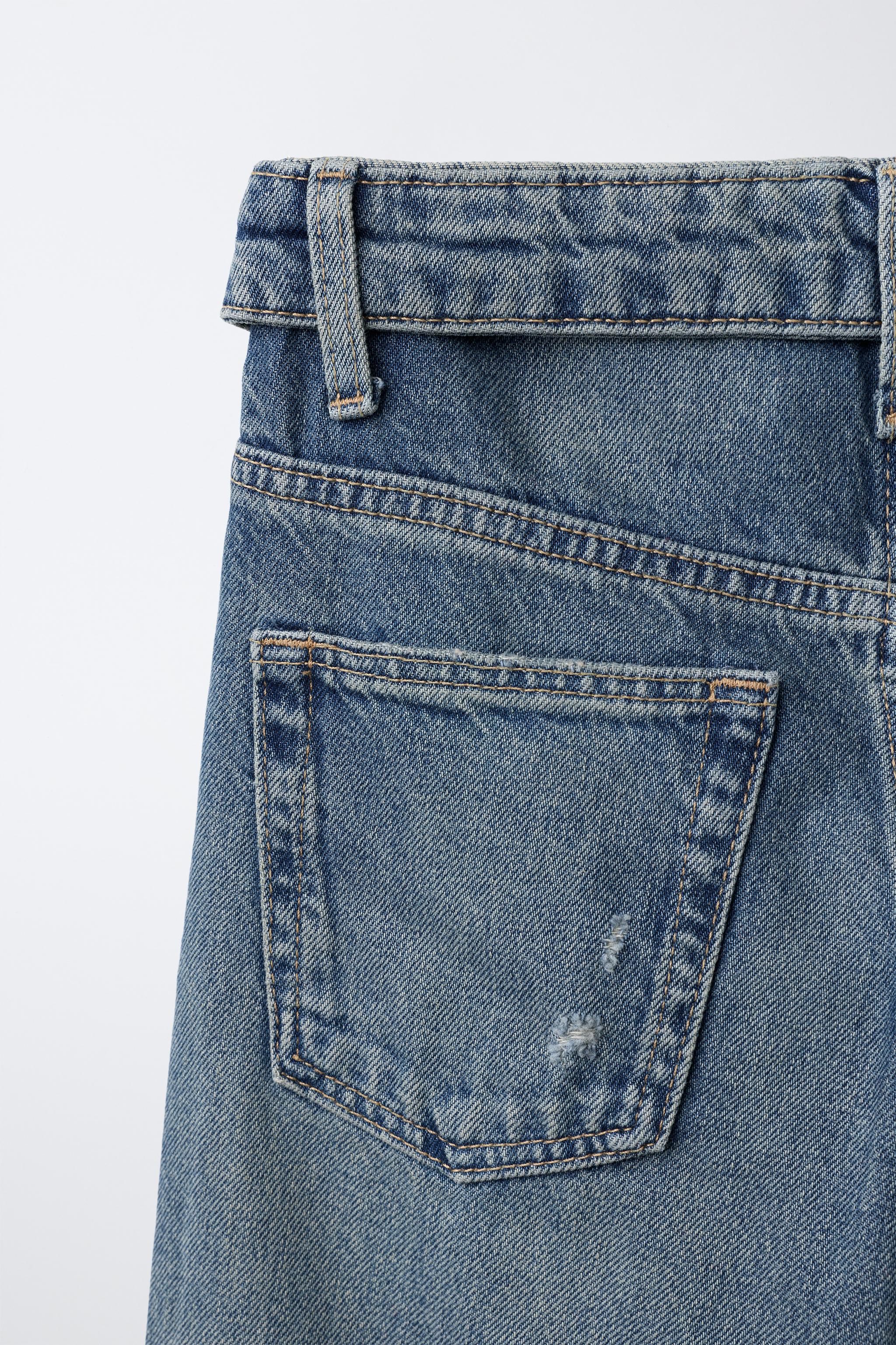 JEAN À JAMBES LARGES DÉCHIRÉ