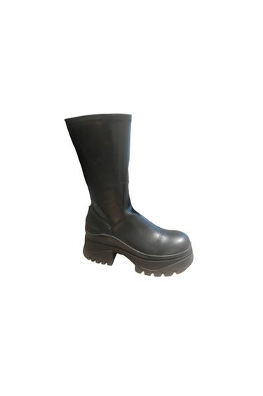Black high boot with a thick, cleated sole, side view on a white background.