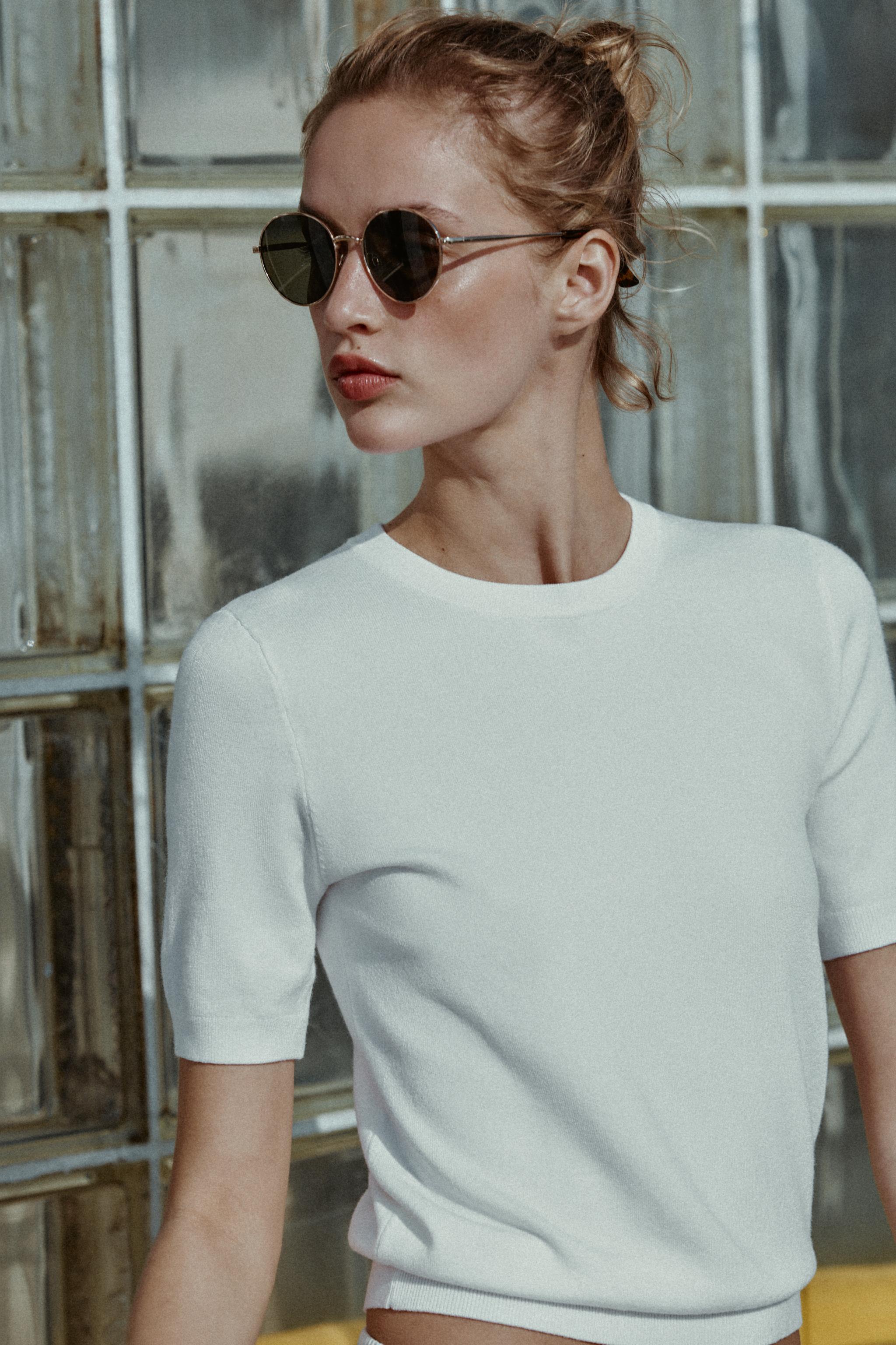 Medium shot of a white, short-sleeved, crew-neck t-shirt.