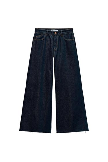Front view of dark wide-leg trousers with front pockets and a button.