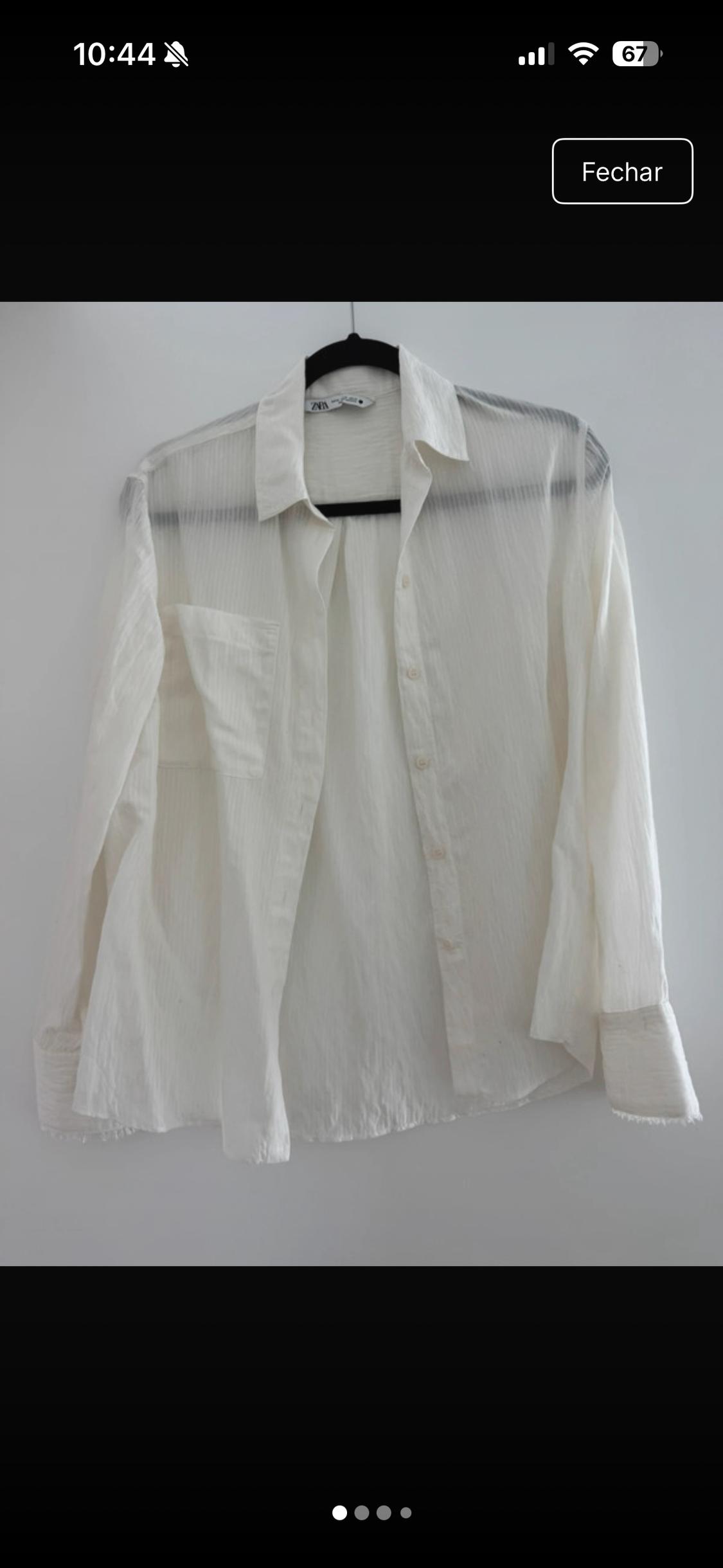 Semi-sheer white long-sleeved shirt with a pocket, on a black hanger against a white background. Text: 10:44, 67, Close, ZARA.