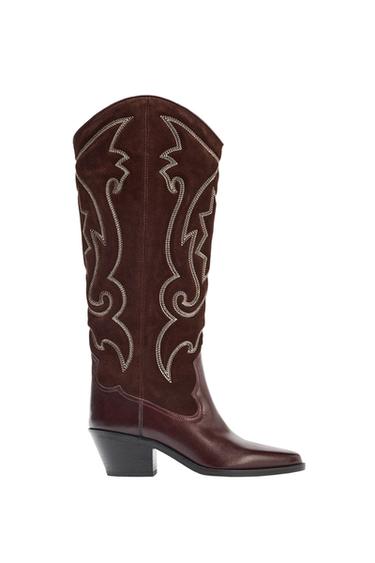 "Side view of a brown, high-legged boot with a Cuban heel and decorative embroidery on the side."