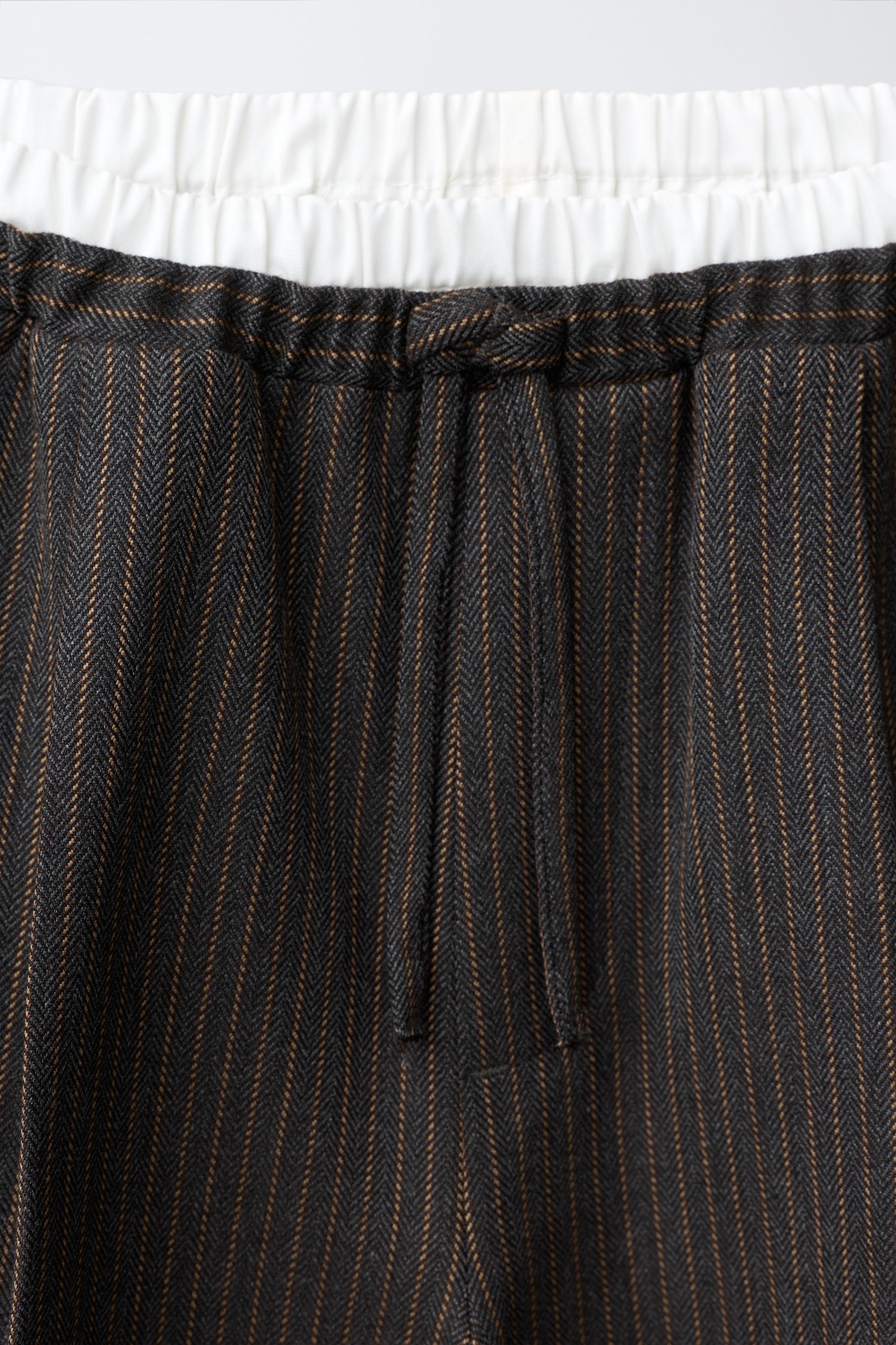PANTALON À JAMBES LARGES RAYURES ET DOUBLE CEINTURE