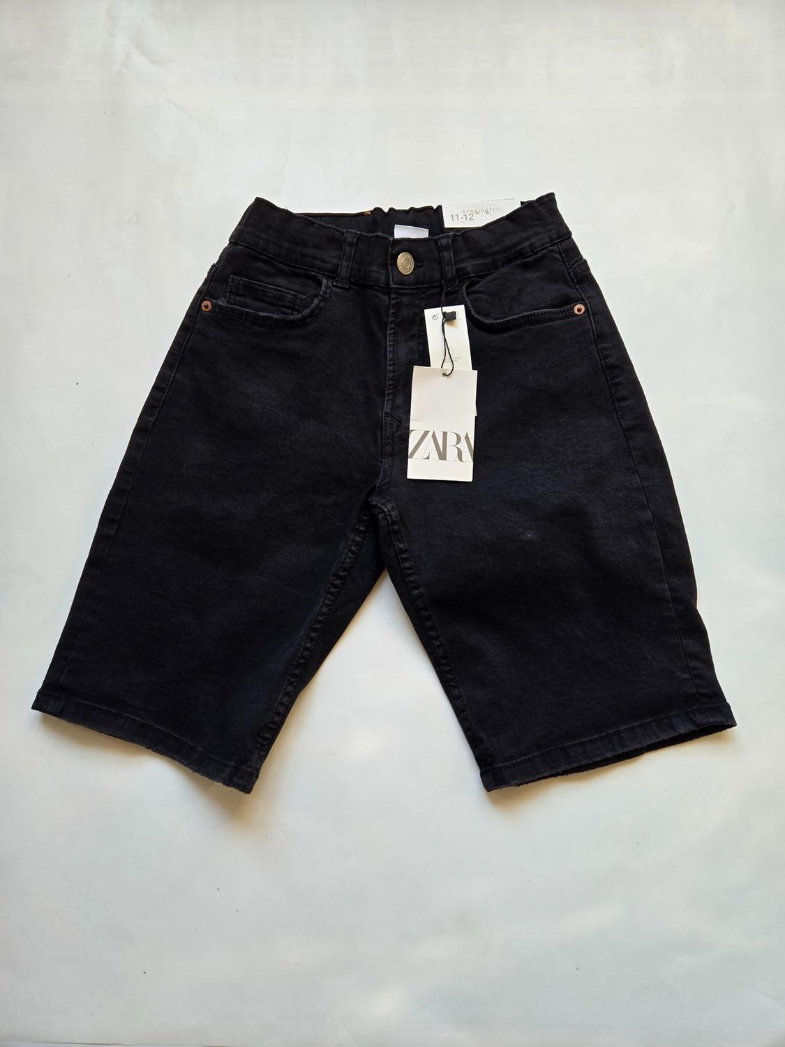Front view of black shorts with front pockets and visible tag.