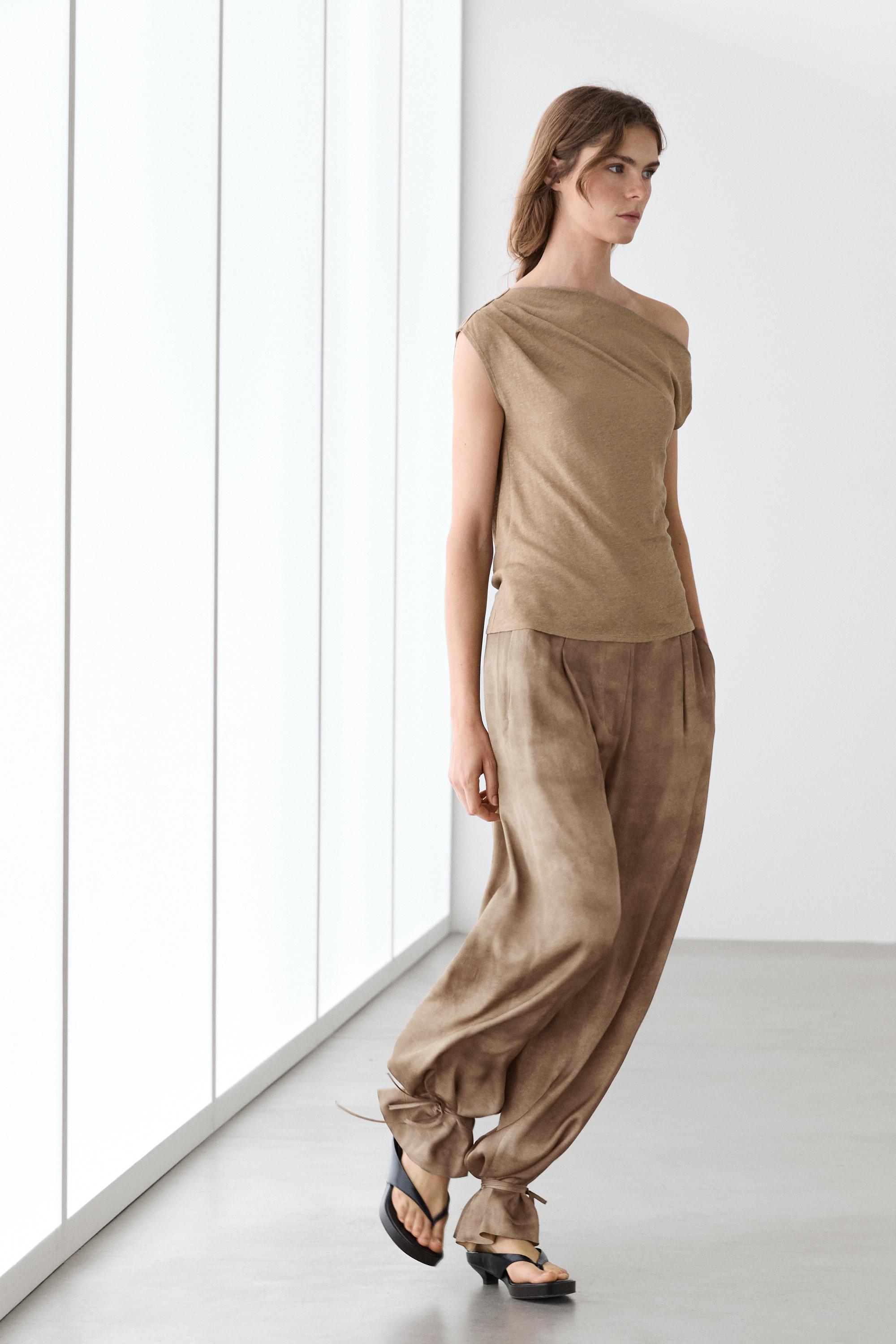 Flowing pants with tie-detail hem — Beige