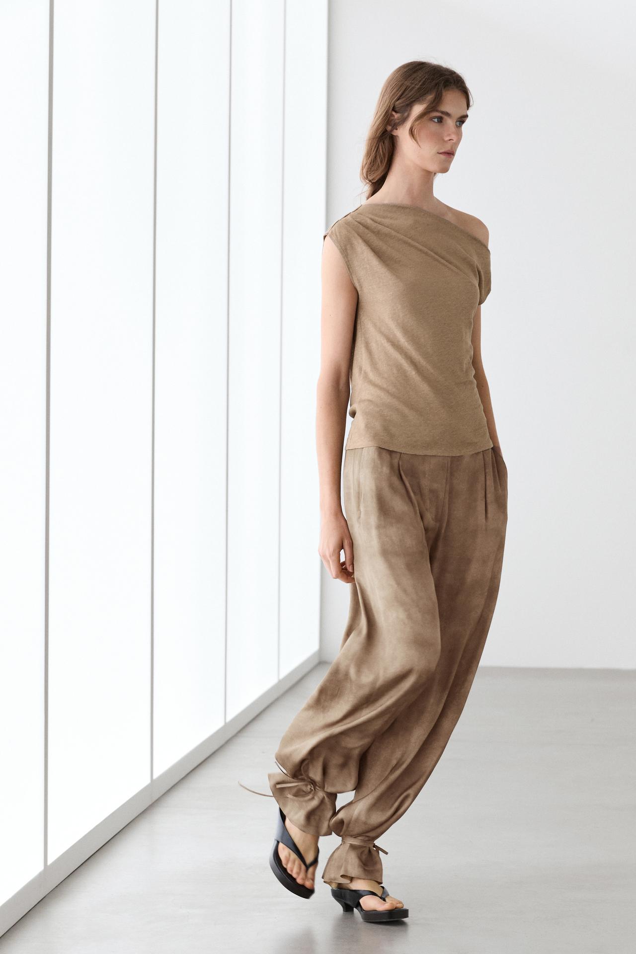 Flowing pants with tie-detail hem — Beige