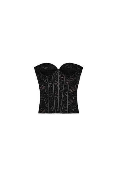 Front view of a black corset with lace, sweetheart neckline, and visible boning. Side fastening with a hidden zip.