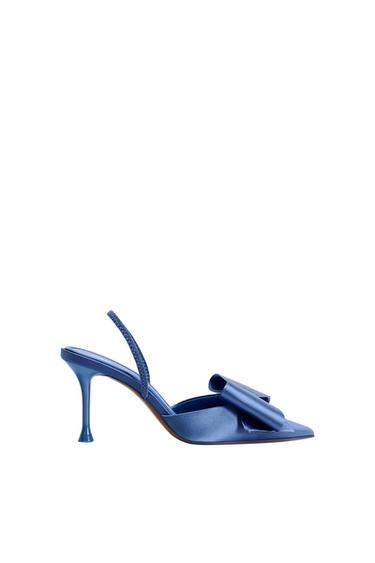 Blue satin court shoe with a pointed toe, bow detail on the front and slingback strap, on a white background.
