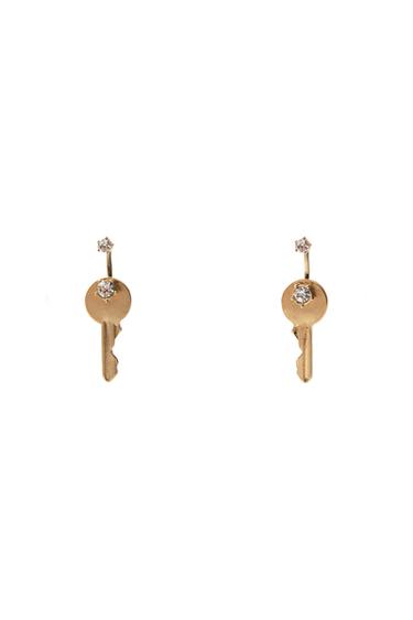 Two gold key-shaped earrings with sparkling crystal details on a white background.