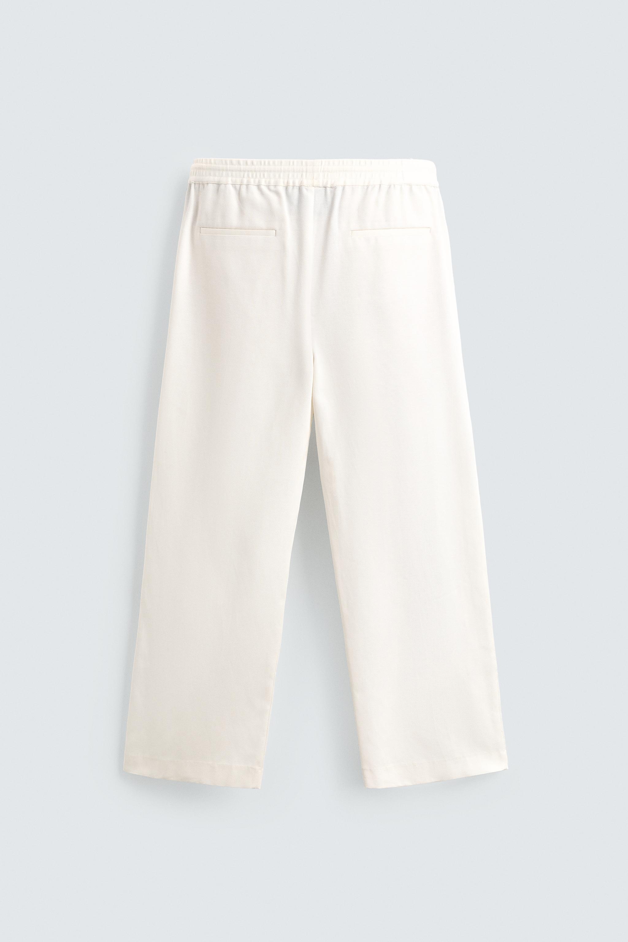 TEXTURED PLEATED PANTS