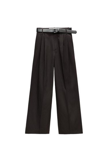 Front view of striped black pants with belt.