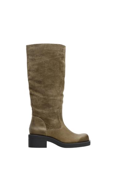 Olive brown high boot with a low heel and black sole, side view on a white background.