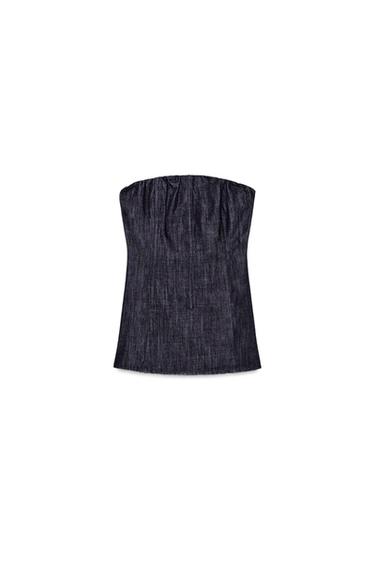 Front view of a dark indigo bustier top with a straight elasticated neckline and a flared hem.
