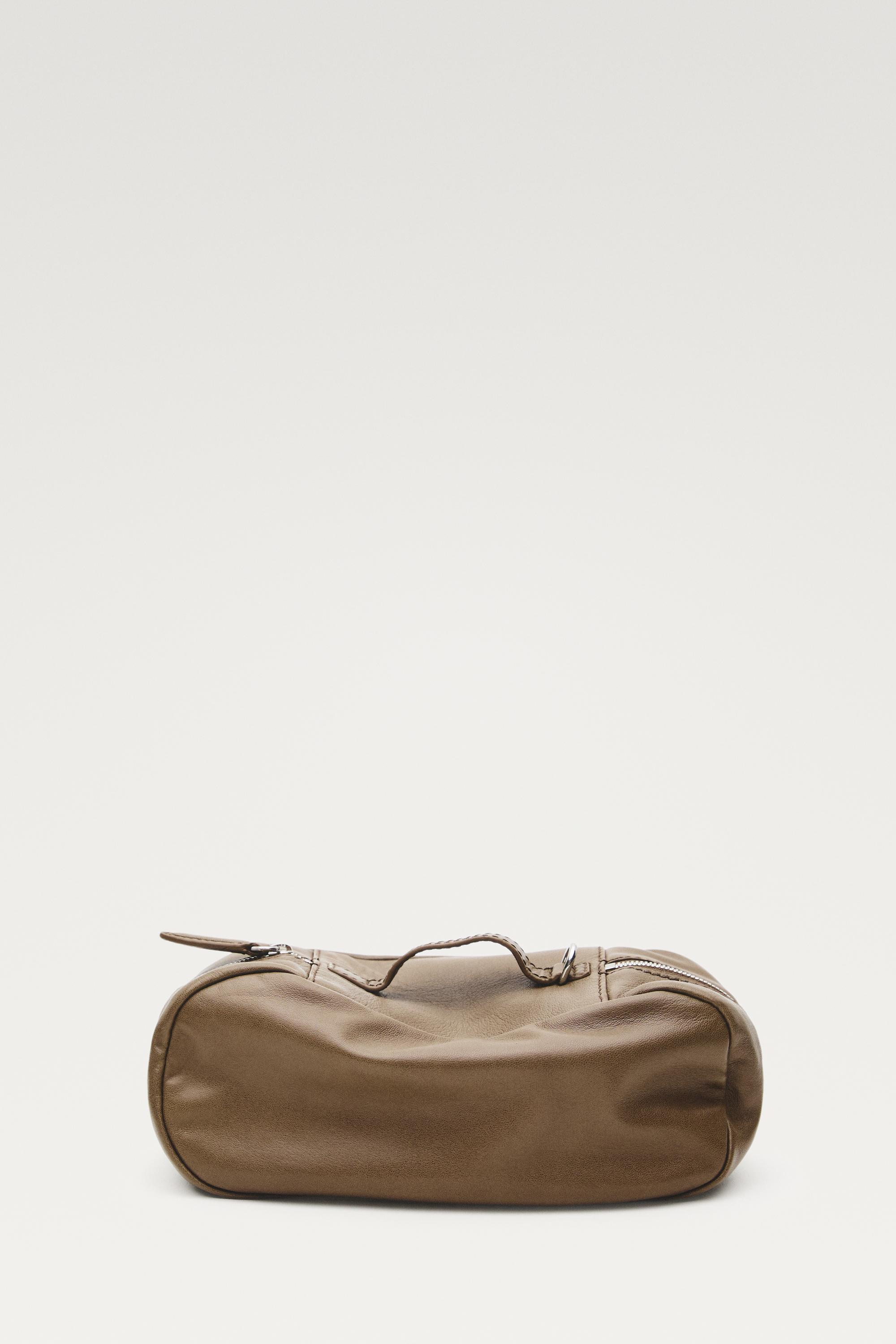 Oval nappa leather toiletry bag — Black gold