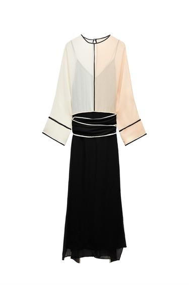 Front view of two-tone dress with long sleeves, black detailing, and belt.