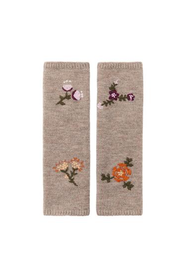 Front view of toasted mittens with floral embroidery in shades of purple, orange, and cream.