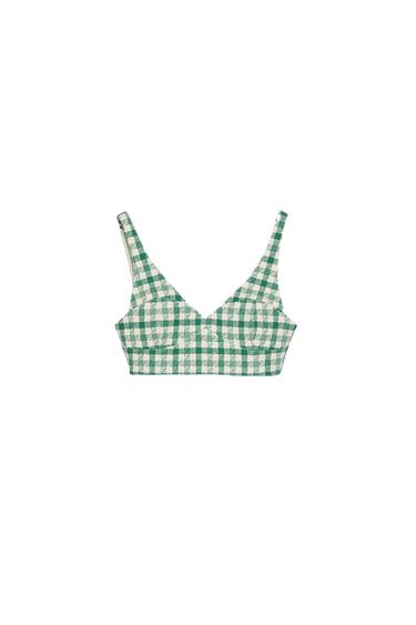 Cropped cami top with a green and white check print on a white background. Simple and modern design.