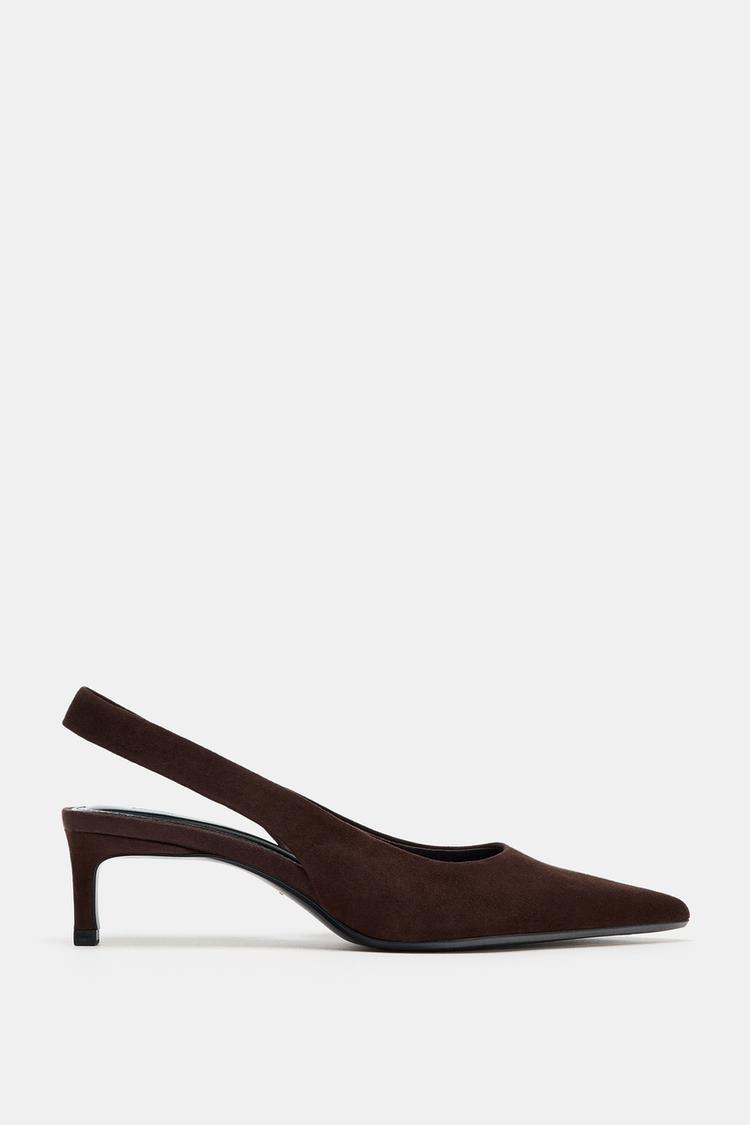 Side view of a chocolate brown high heel shoe with pointed toe and back strap.