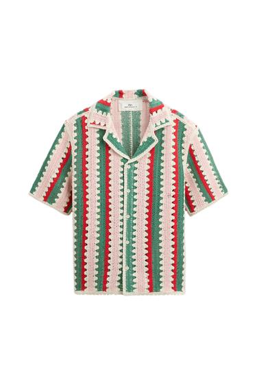 Crochet shirt with vertical stripes in green, red, and white. Short sleeves and an open collar. Visible internal label.