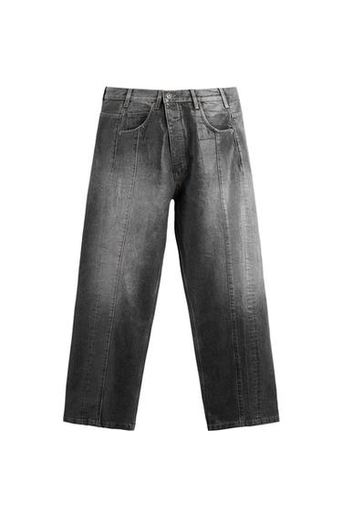 Front view of grey jeans with visible seams and side pockets.