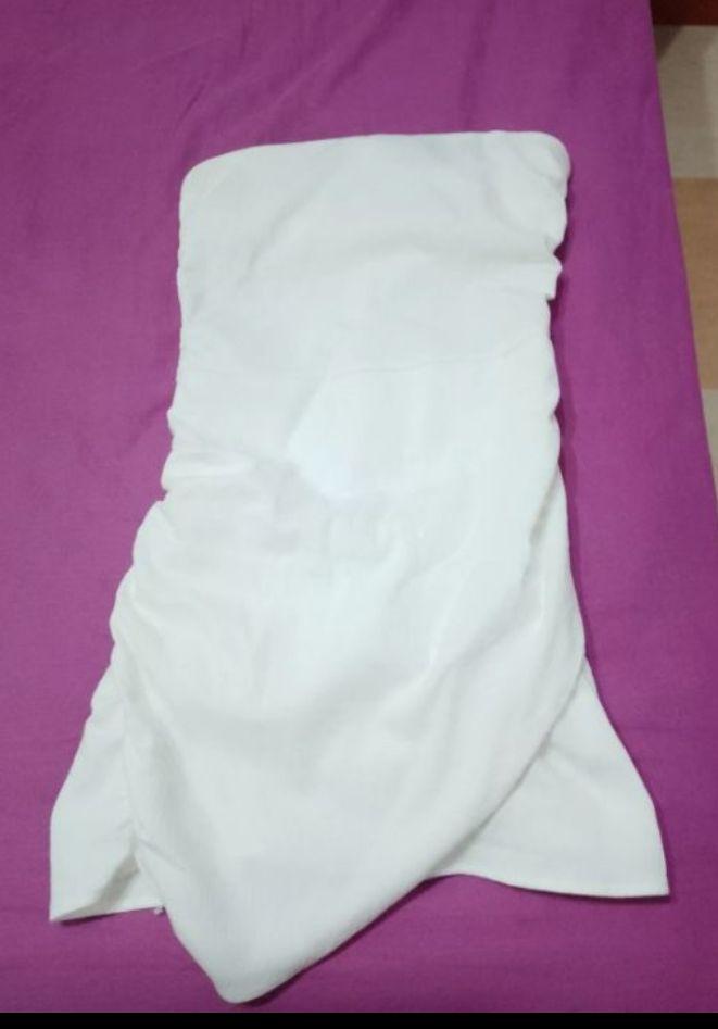 Crinkled white fabric on a purple surface.