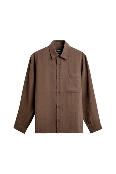Brown long-sleeved button-up shirt with a chest pocket, on a white background. The neck label shows the text ZARA.