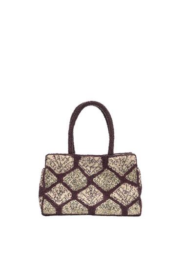 Beaded bag with a geometric diamond pattern in burgundy and cream tones. Design with two short top handles on a white background.