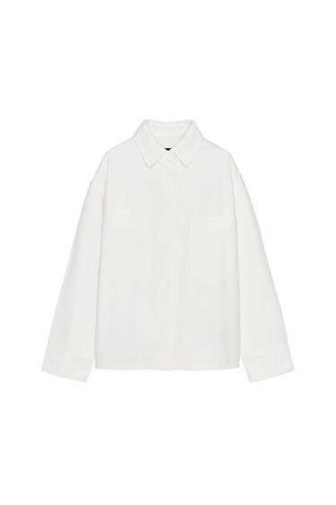 Front view of white shirt with front pockets.