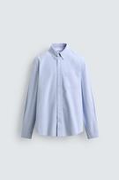 Front view of a regular fit light blue shirt with a button-down collar, long sleeves, and a patch pocket on the chest.