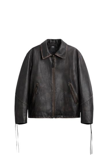 Front view of a black jacket with a zipper and zippered side pockets.