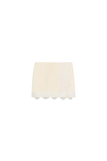 Front view of a yellow culotte skirt with white lace trim and a front split. Concealed side zip.