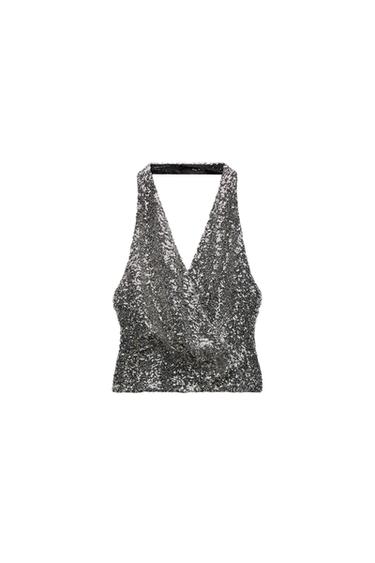 Front view of a backless silver sequin top.