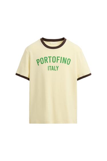 Beige t-shirt with brown trim on the collar and sleeves. Green text: "PORTOFINO ITALY". White background.