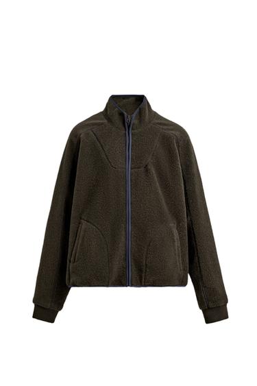 Front view of a brown sweatshirt with a faux fur texture, a high neck with a zip, long sleeves, and welt pockets at the hip.
