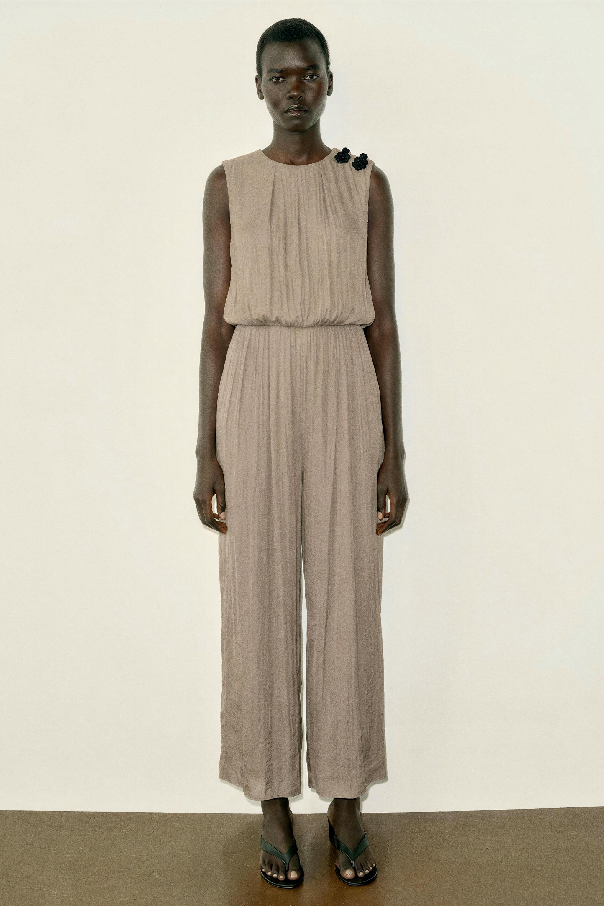SATIN JUMPSUIT WITH SHOULDER FROG FASTENING