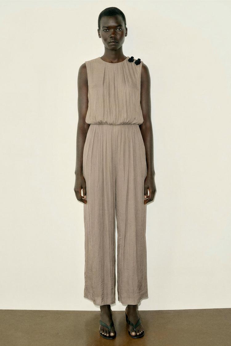 SATIN JUMPSUIT WITH SHOULDER FROG FASTENING