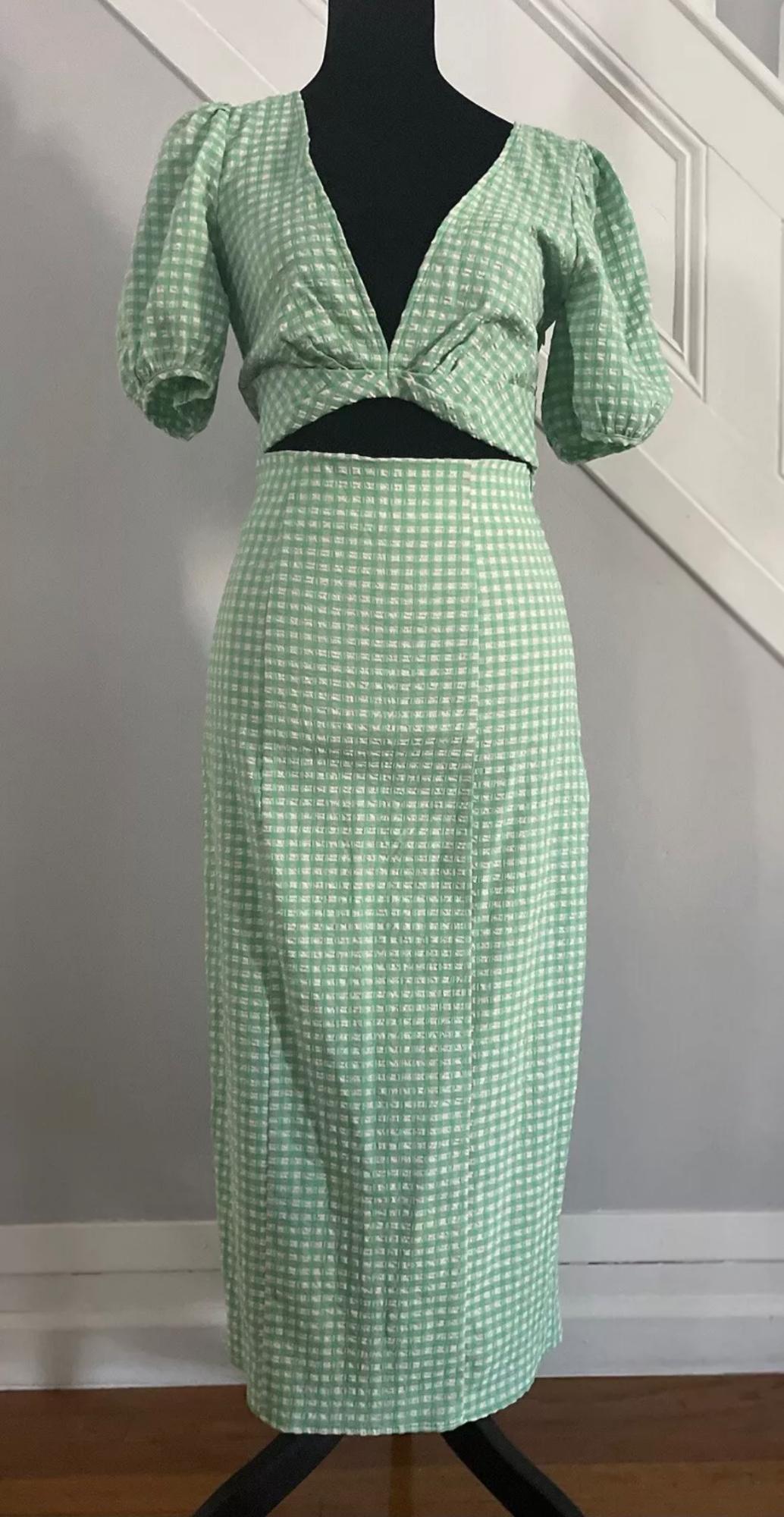Front view of a green checked co-ord set with short puffed sleeves and a wrap neckline.