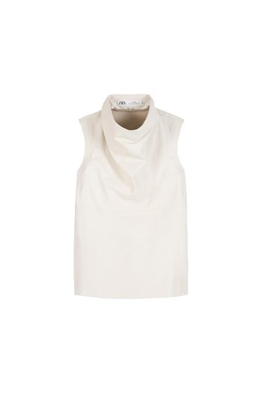 Sleeveless ecru top with a draped neckline on a white background. Inner label with the text ZARA.
